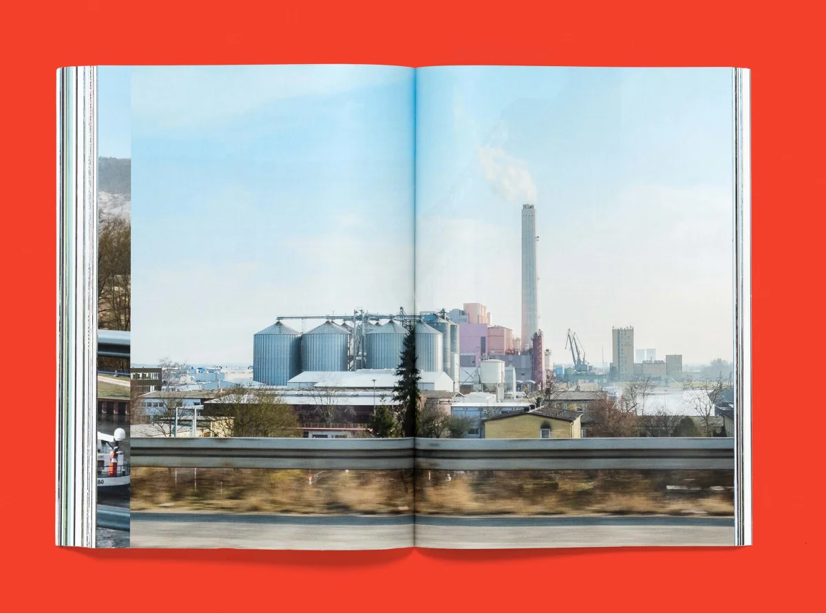 Full-spread photograph of an industrial area with silos and chimneys in “Bayern, München”.