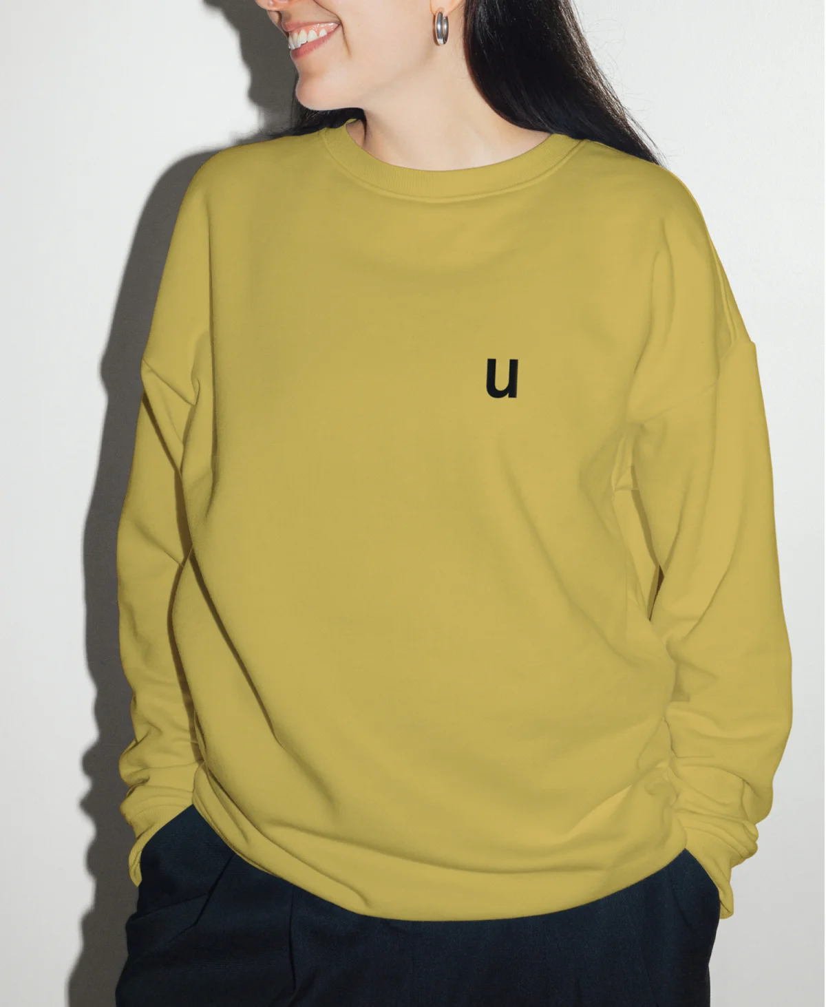 Front view of the yellow-green sweatshirt with a single black u on the chest.