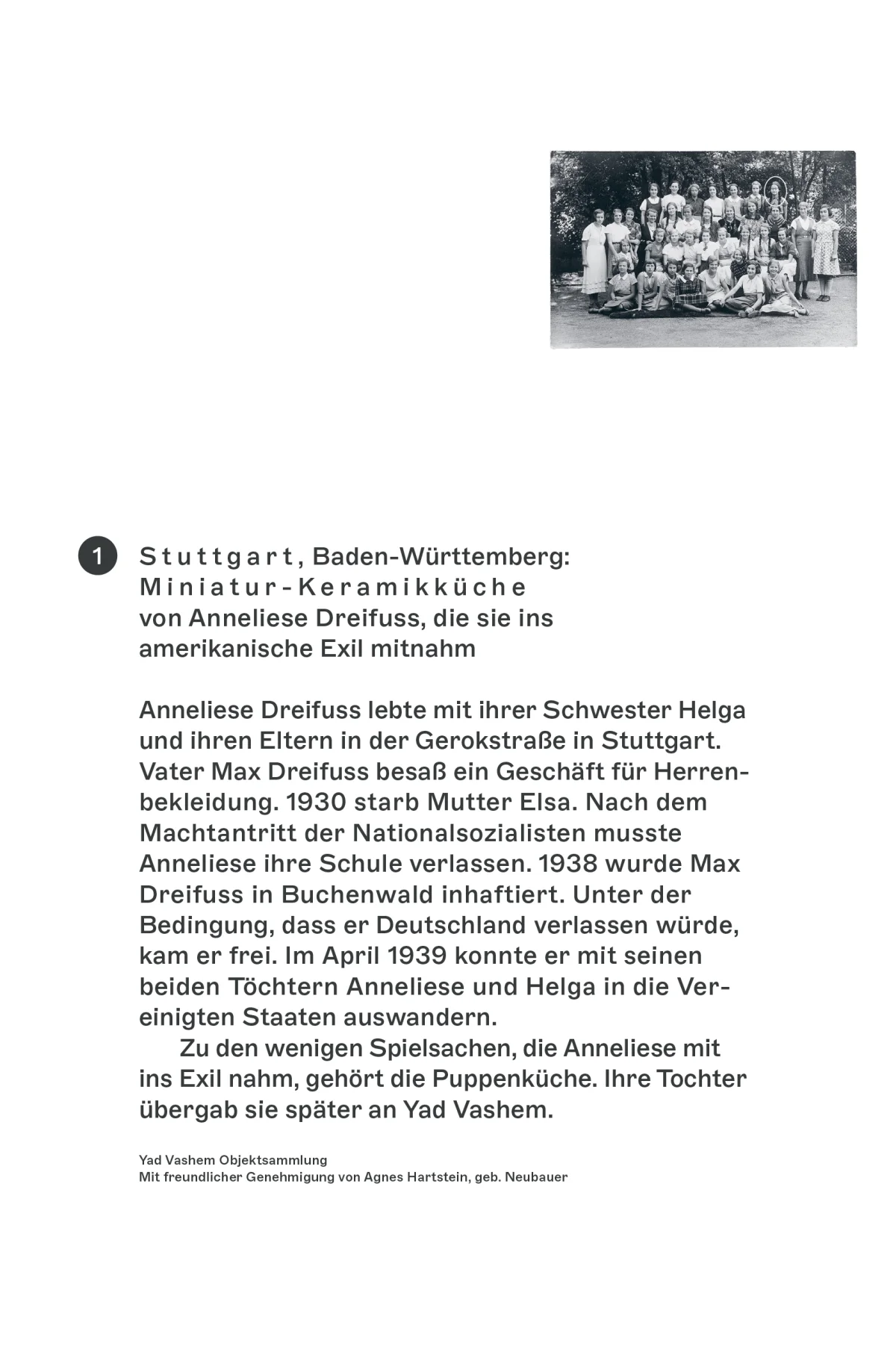 White exhibition panel about Anneliese Dreifuss’s miniature ceramic kitchen, with a historical group photograph and biography.