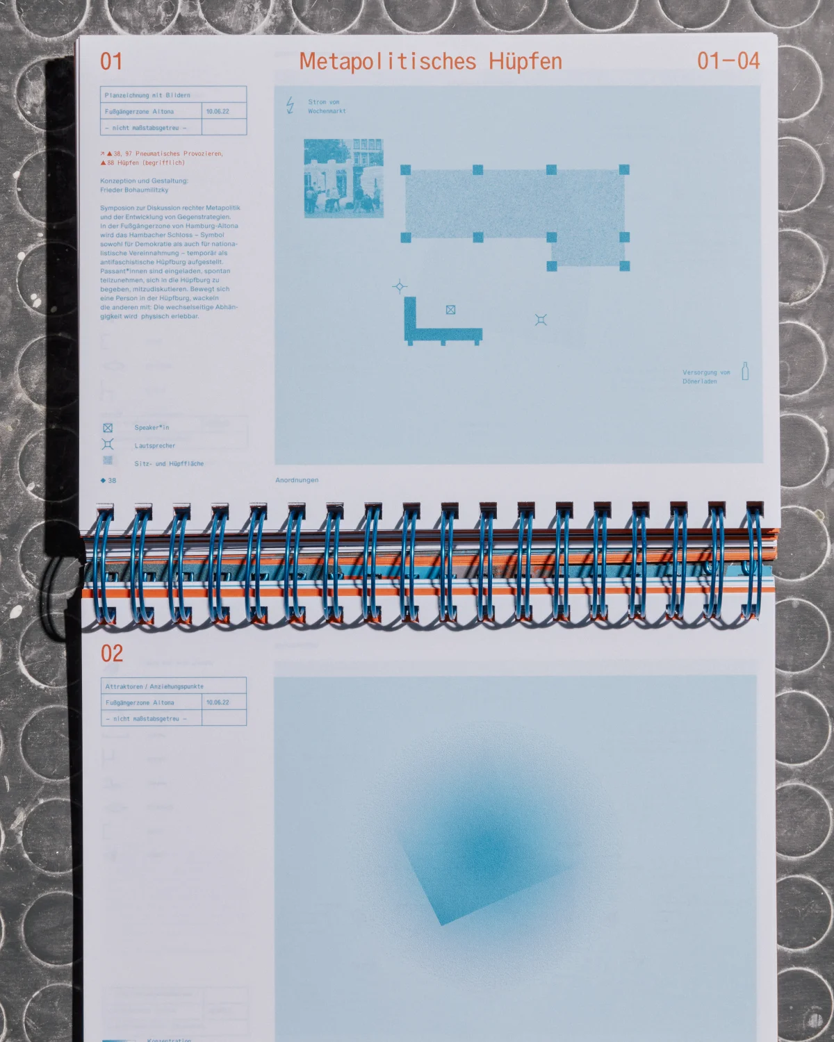 Open “Specology” volume with two chapter openings, pale blue graphics and horizontally running spiral binding.
