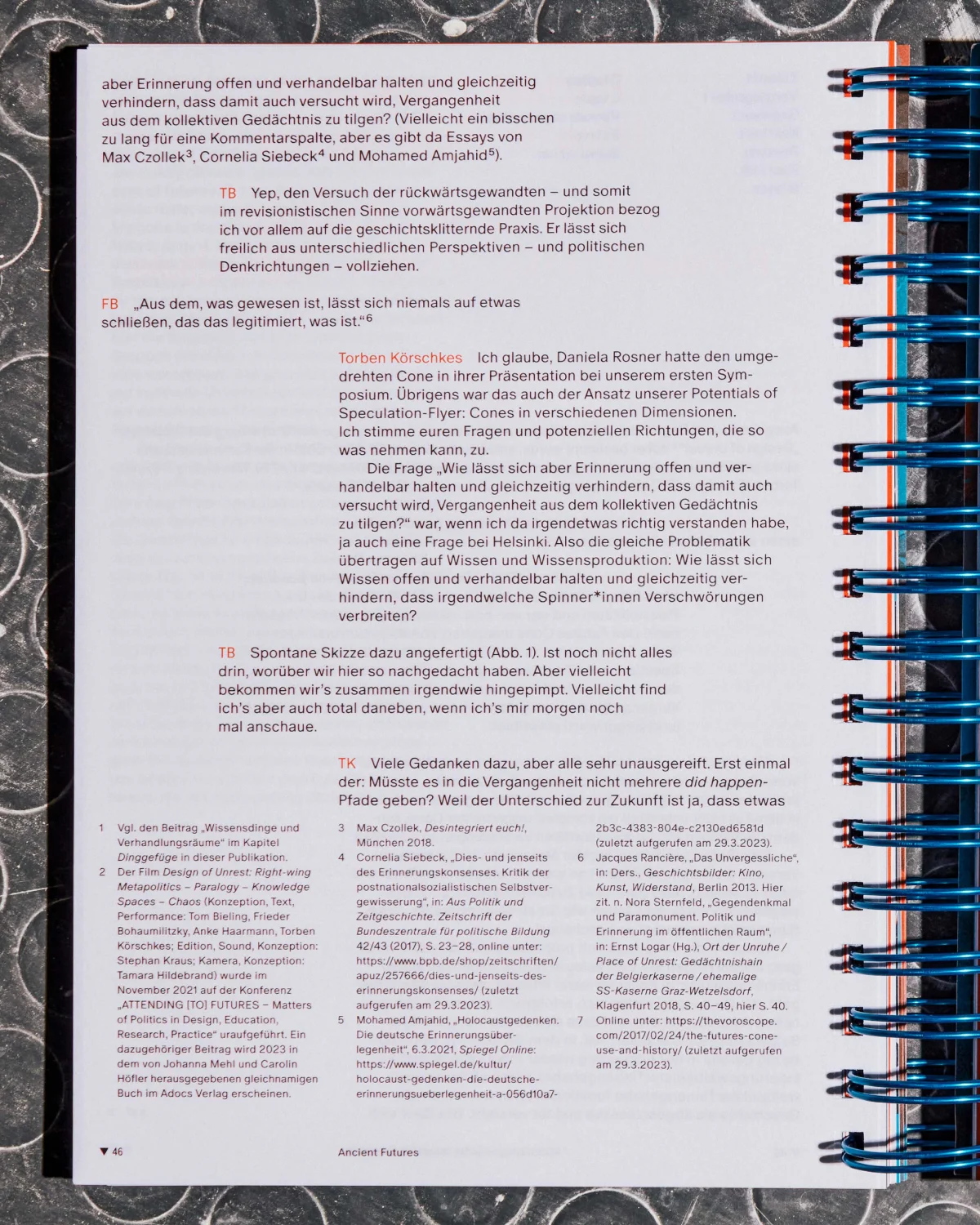“Specology” text page with conversational passages, orange highlights and a dense footnote section.