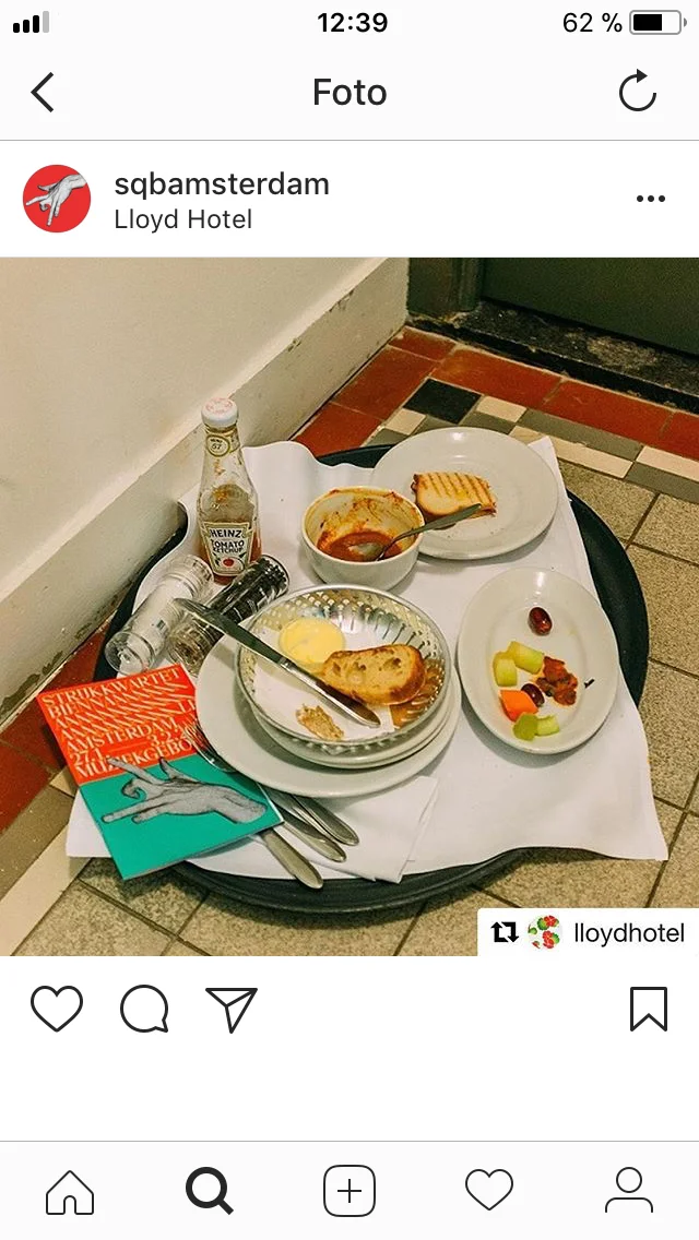 Instagram post showing a breakfast tray with small red and turquoise Biennale printed items.