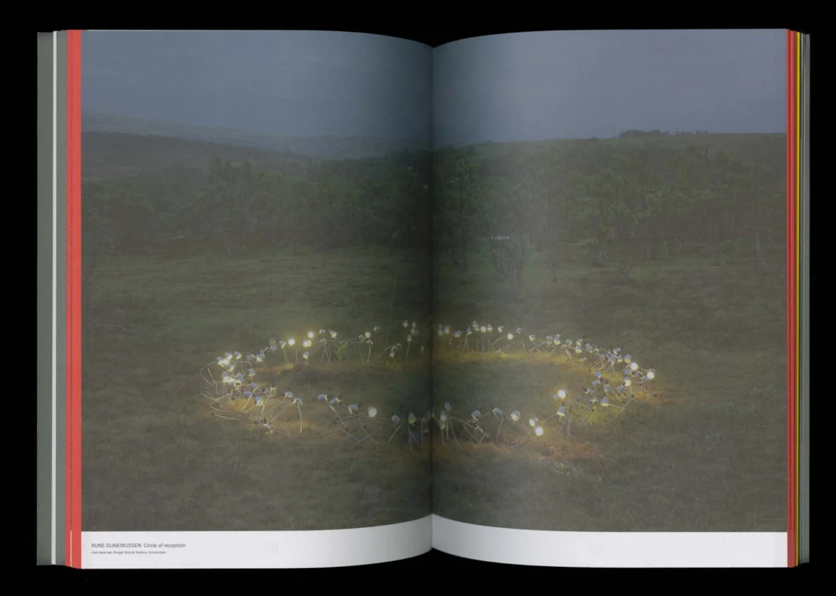 Programme spread featuring a landscape photograph with a ring of white flowers in the grass.