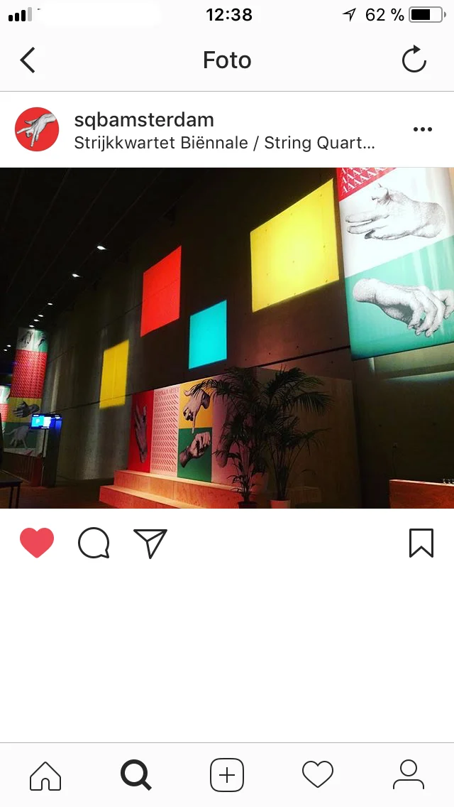 Instagram post showing coloured wall panels and Biennale posters inside the venue.