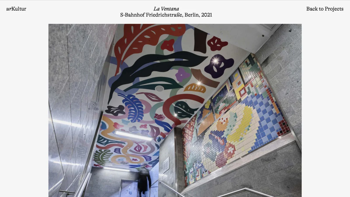 urKultur project page “La Ventana”, showing colourful ceiling painting and wall mosaics beside a staircase.